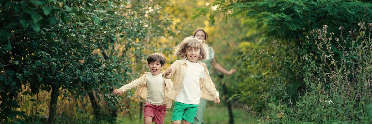 Kids playing running on plot in country house. Ecological life outside city