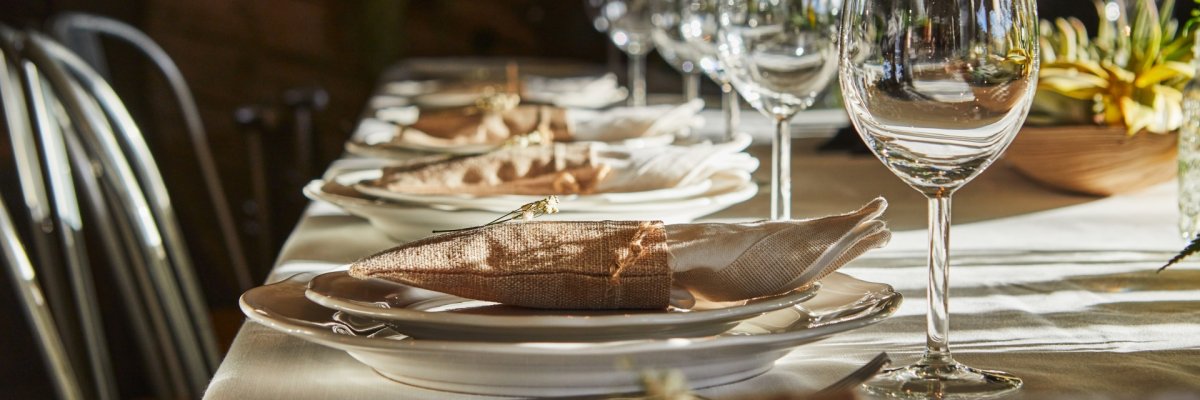 Laid table with cutlery and crockery in the sunset sunlight Laid table with cutlery and crockery in the sunset sunlight