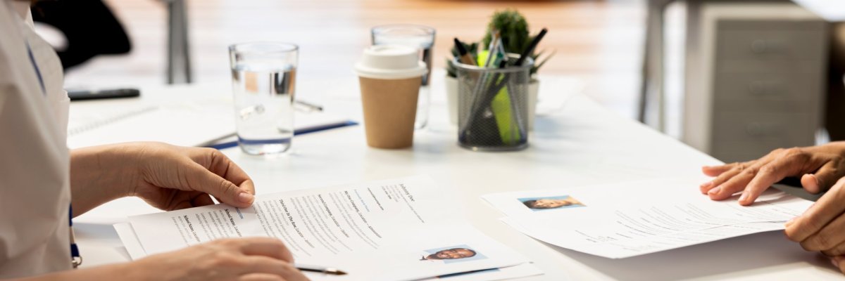 Recruiter presenting salary package to applicant on device screen, close up