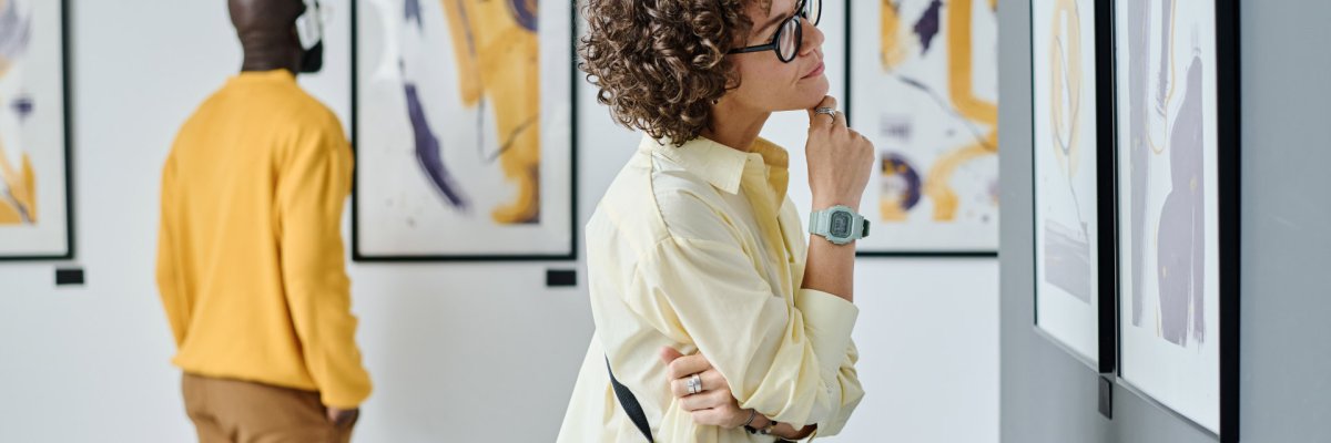Woman examining modern art at gallery Woman examining modern art at gallery