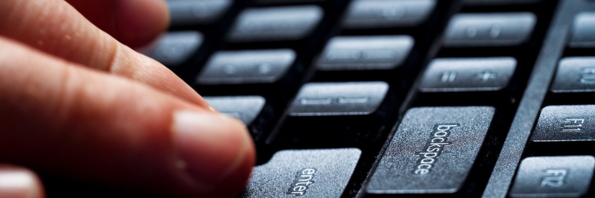 Fingers typing on computer keyboard.