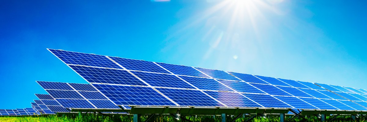Blue solar panels under deep blue sky