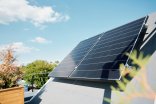 Large solar panels on rooftop of modern comfortable house or cottage